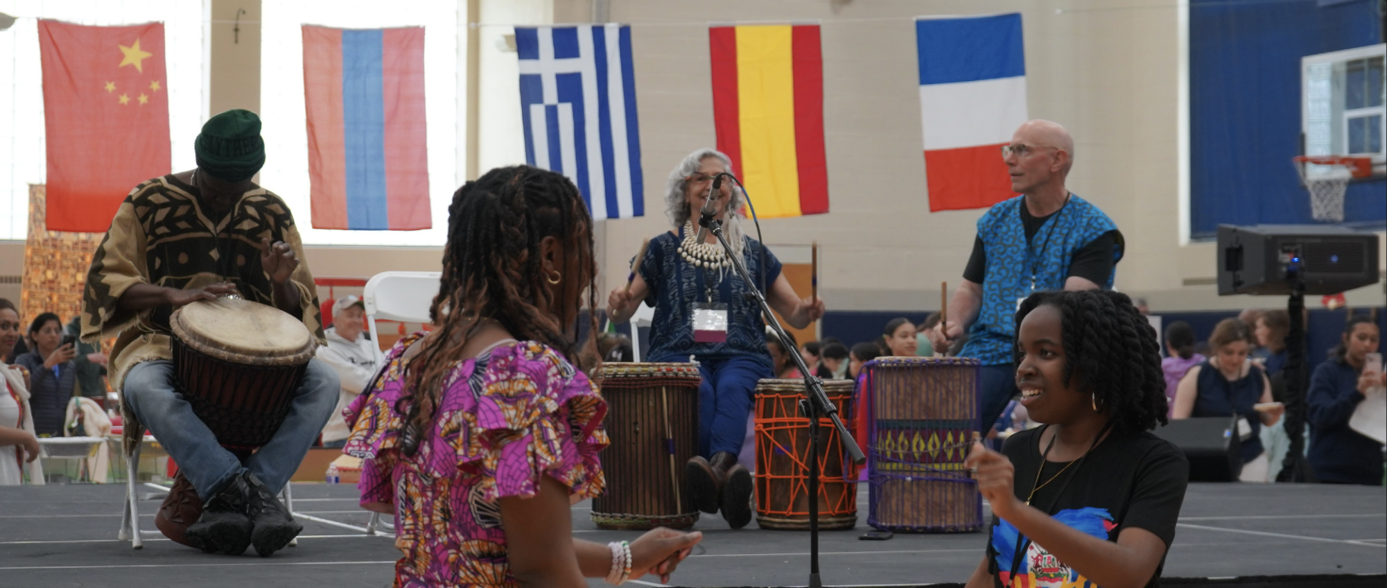 Lauyanne Kouame and Isabel Doricent (both ’26) dance to African drumming during One School One World. (Staff Photo by Olivia Richter)